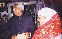 Bibi Jagir Kaur receives a siropa at the Chawinda Devi temple on Wednesday. 