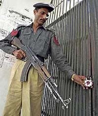 A policeman shows a padlocked gate