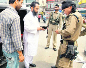 Personnel of the Special Task force of the Jammu and Kashmir police conduct a surprise check at Regal Chowk in Srinagar on Sunday. 